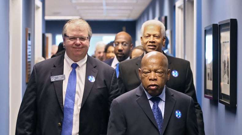 U.S. Rep. John Lewis, front, U.S. Rep. Hank Johnson, center, and Senate Minority Leader Steve Henson prepare for a Democratic Party of Georgia get-out-the-vote effort this weekend. Georgia Democrats hit the road Friday for a final, last-ditch effort to turn out voters as polls show the race between Hillary Clinton and Donald Trump remains close in the state. They gathered for breakfast at the Georgia Democratic Party office in Atlanta, where party leaders laid out their battle plan before splitting up and hitting the road Friday morning. BOB ANDRES /BANDRES@AJC.COM