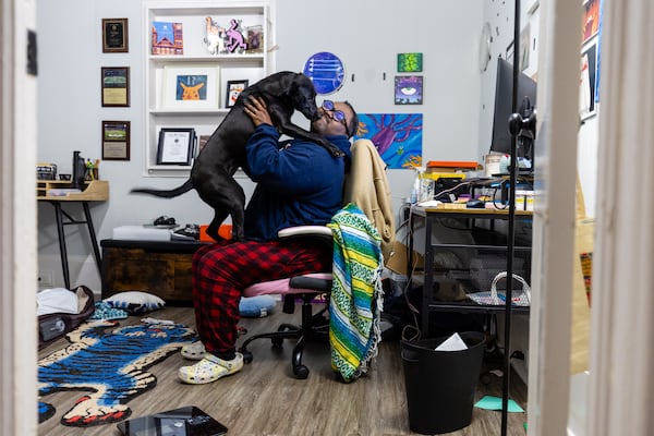 Webb, pictured with Sadie, one of his three dogs, works from home as a content marketing manager. It took a little more than three weeks before he could return to work after surgery, because of complications. 