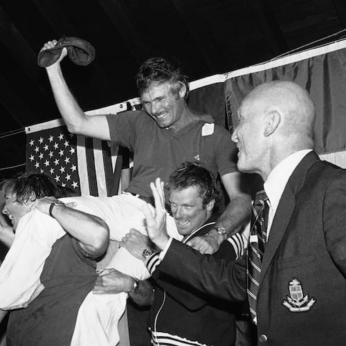FILE - Ted Turner, center, is carried off by his crew following a news conference after his vessel Courageous won the Americas Cup sailing race, Sept. 19, 1977, in Newport, R.I. At right is Bill Ficker, skipper of cup winner Intrepid in 1970. (AP Photo/J. Walter Green, File)