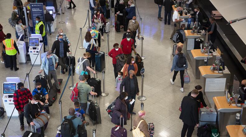 People wait in line at the Delta check-in at the South Terminal at the Hartsfield-Jackson International Airport December 27, 2021  STEVE SCHAEFER FOR THE ATLANTA JOURNAL-CONSTITUTION