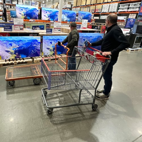 FILE - Shoppers stop their carts to observe big-screen televisions on display in a Costco warehouse Thursday, April 30, 2026, in Timnath, Colo. (AP Photo/David Zalubowski, File)