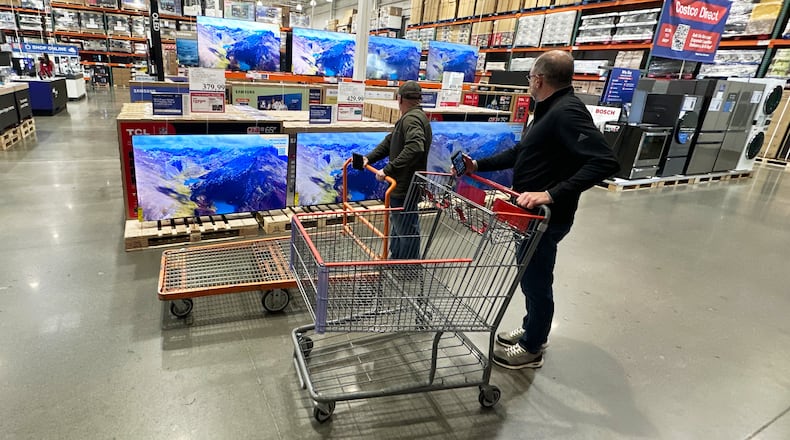 FILE - Shoppers stop their carts to observe big-screen televisions on display in a Costco warehouse Thursday, April 30, 2026, in Timnath, Colo. (AP Photo/David Zalubowski, File)
