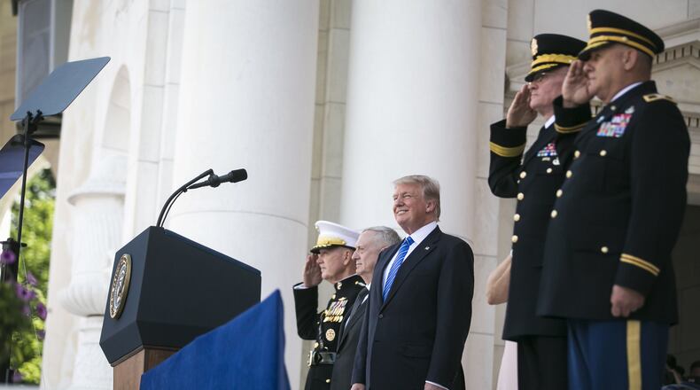 From left: Joint Chiefs Chairman Gen. Joseph Dunford, Defense Secretary Jim Mattis, and President Donald Trump during a Memorial Day ceremony at Arlington National Cemetery in Arlington, Va., May 29, 2017. On Wednesday, Trump announced the government would not “accept or allow” transgender people to serve in the U.S. military. (Al Drago/The New York Times)