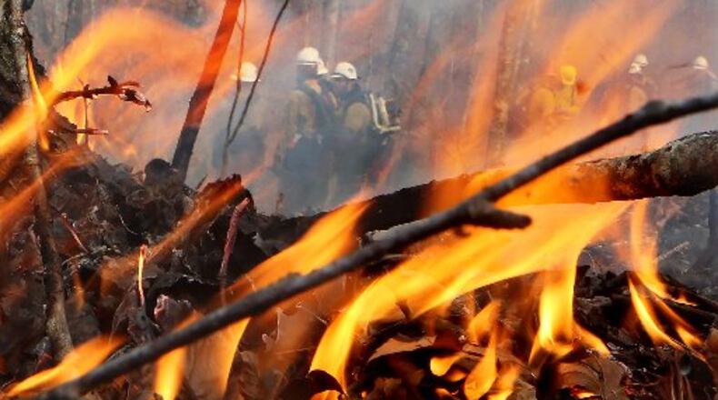 A crew from California works at the Rock Mountain fire in Rabun County. That fire was 55 percent contained Wednesday. CURTIS COMPTON / CCOMPTON@AJC.COM