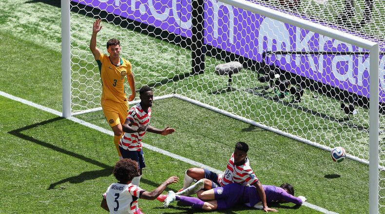 Australia's Aiden O'Neill (13) appeals for offside after United States' Alex Freeman (16) scored a goal past Australia goalkeeper Patrick Beach (18) during the World Cup Group D soccer match between the United States and Australia in Seattle, Friday, June 19, 2026. (AP Photo/Maddy Grassy)