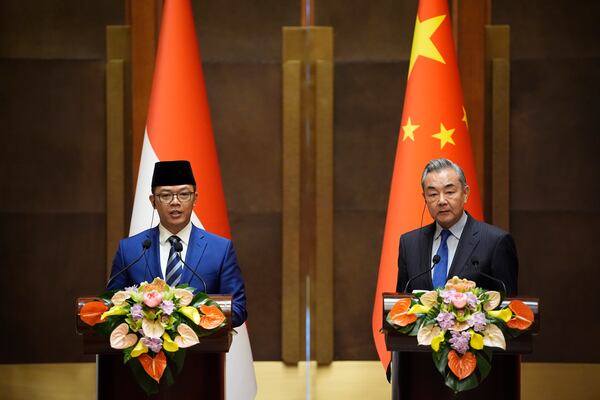Indonesian Foreign Minister Sugiono, left, and Chinese Foreign Minister Wang Yi attend a press briefing after the first meeting of China-Indonesia joint foreign and defense ministerial dialogue at the Diaoyutai State Guest House Monday, April 21, 2025 in Beijing, China. (Iori Sagisawa/Pool Photo via AP)