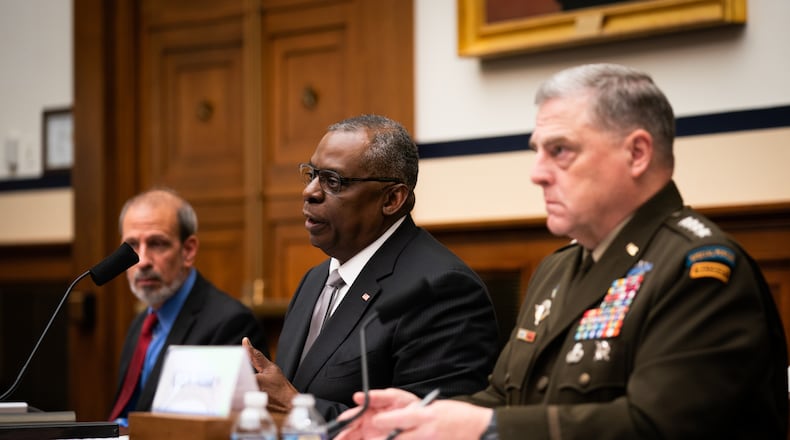 Secretary of Defense Lloyd Austin, center, testifies at a hearing of the House Committee on Armed Services on Capitol Hill in Washington on Wednesday, as Gen. Mark Milley, right, chairman of the Joint Chiefs of Staff, looks on. The two leaders found themselves having to dismiss questions about whether efforts to root out extremists in the military ranks meant going after soldiers’ political views.