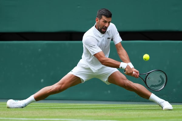 Novak Djokovic of Serbia returns to Miomir Kecmanovic of Serbia during a third round men's singles match at the Wimbledon Tennis Championships in London, Saturday, July 5, 2025. (AP Photo/Kirsty Wigglesworth)