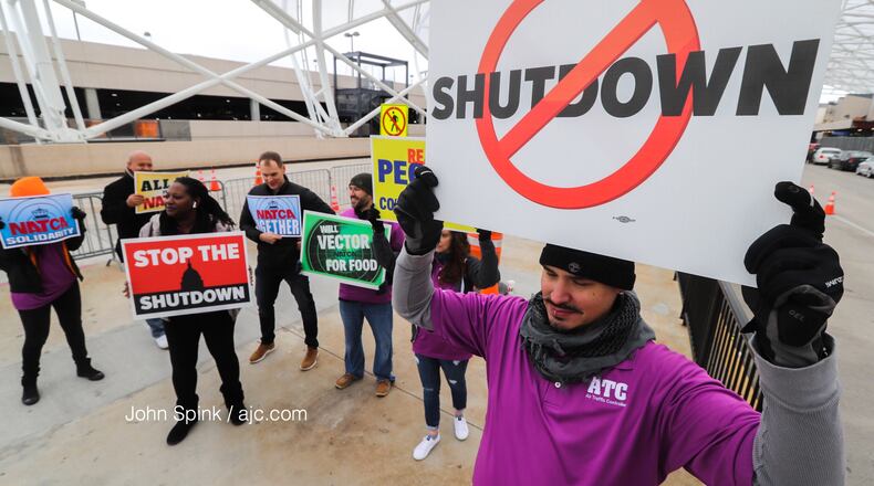 Air traffic controller Rafael Naveira and fellow ATC workers protest the federal shutdown at the north terminal.