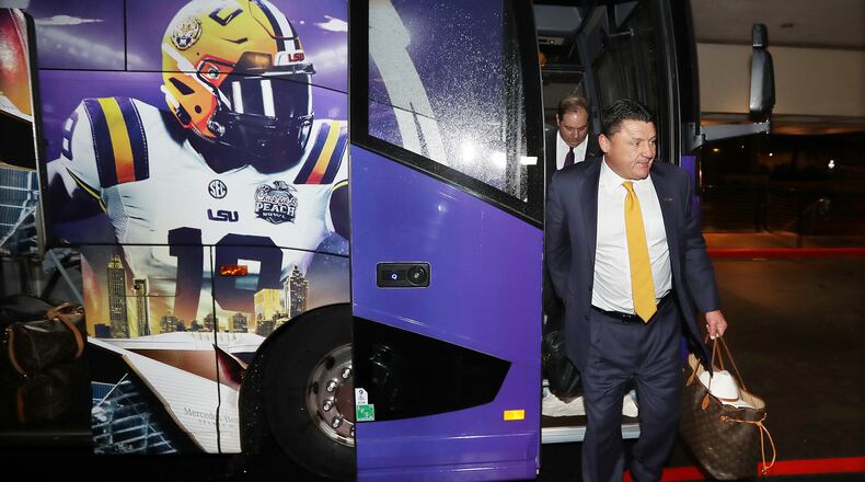LSU head coach Ed Orgeron steps off the team bus as it arrives at the team hotel ahead of the Chick-fil-A Peach Bowl - a College Football Playoff semifinal - Sunday, Dec. 22, 2019, in Atlanta.