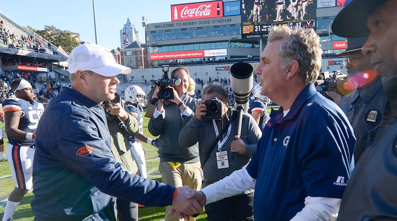 Virginia head coach Bronco Mendenhall shakes hands with Georgia Tech head coach Paul Johnson after the Yellow Jackets beat the Cavaliers 31-17 Saturday, November 19, 2016. SPECIAL/Daniel Varnado