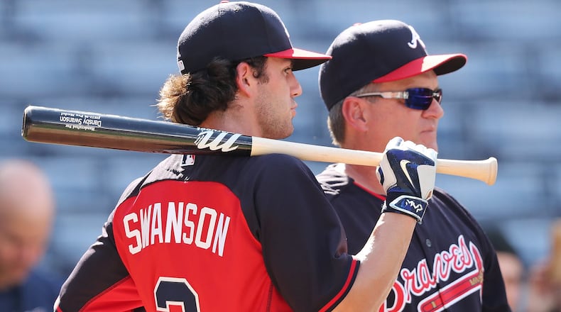 Dansby Swanson, here chatting with hitting coach Kevin Seitzer, entered the season-ending series against Detroit with a .300 average through his first 35 games, and the respect of his manager for doing things the right way (Curtis Compton/AJC file photo)