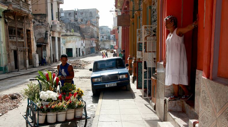 A flower salesman pushes his cart down a street in Havana. While the Internet is essential for today's business, Cuba still has some of the worst Internet access in the world.