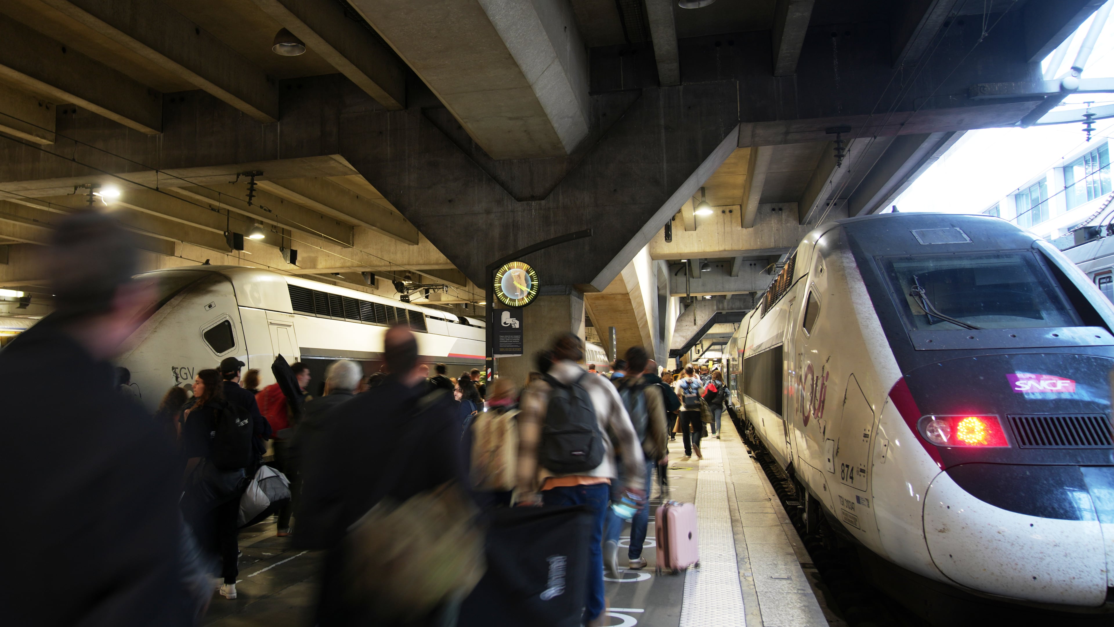 People board a high-speed train at the Montparnasse train station after a man wielding a knife at the station was shot and wounded by police, Friday, Nov. 14, 2025 in Paris. (AP Photo/Christophe Ena)