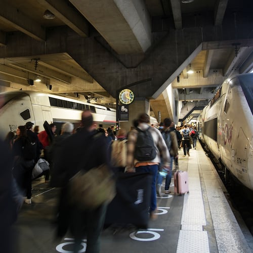 People board a high-speed train at the Montparnasse train station after a man wielding a knife at the station was shot and wounded by police, Friday, Nov. 14, 2025 in Paris. (AP Photo/Christophe Ena)