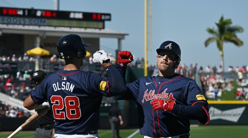 Atlanta Braves third baseman Austin Riley  celebrates with first baseman Matt Olson (28) after hitting a solo home run during the fourth inning of the home opener spring training baseball game at CoolToday Park, Feb. 25, 2024, in North Port, Florida. (Hyosub Shin / Hyosub.Shin@ajc.com)
