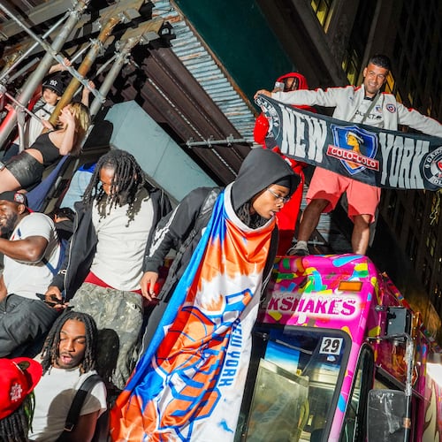 New York Knicks fans celebrate on the street outside of a watch party in Bryant Park for Game 3 of the NBA Finals basketball series between the Knicks and the San Antonio Spurs, Monday, June 8, 2026, in New York. (AP Photo/Ryan Murphy)