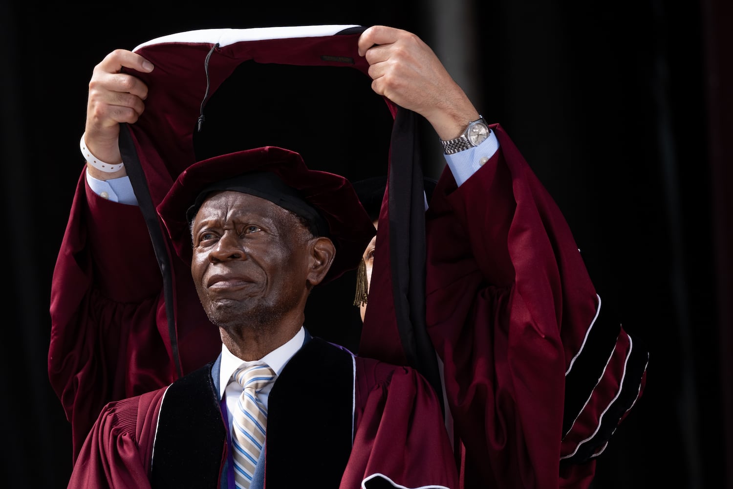 The Rev. Dean Lawrence Carter Sr., founding dean of the Martin Luther King Jr. International Chapel at Morehouse College, receives an honorary Doctor of Humane Letters during graduation Sunday, May 17, 2026. (Ben Gray for the AJC)