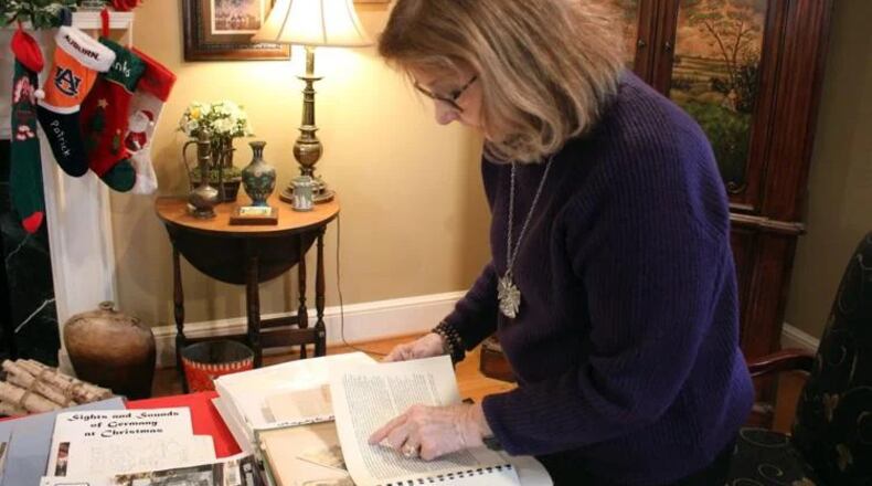 Janet Byington goes through the scrapbook of her father, Lt. Archibald Farrar, from his time fighting in World War II. (Photo Courtesy of Rachel Hartdegen)