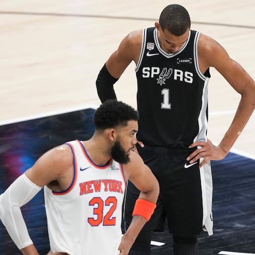 San Antonio Spurs forward Victor Wembanyama (1) looks down as New York Knicks center Karl-Anthony Towns (32) looks towards his bench during the second half of Game 1 of the NBA Finals basketball series, Wednesday, June 3, 2026, in San Antonio. (AP Photo/Eric Gay)