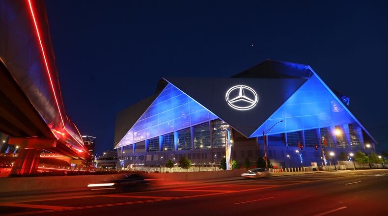 Mercedes-Benz Stadium transforms into a beacon of blue as part of an initiative to salute essential workers on the frontlines of the coronavirus pandemic on Thursday, April 9, 2020, in Atlanta.