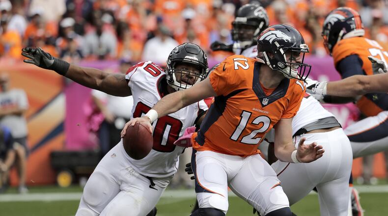 Broncos quarterback Paxton Lynch (12) scrambles as Falcons defensive end Derrick Shelby (90) pursues during the first half of an NFL football game, Sunday, Oct. 9, 2016, in Denver. (AP Photo/Jack Dempsey)