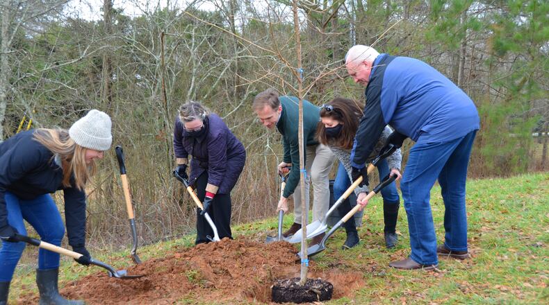 City Arborist Sandra DeWitt, Christine Law, Mayor Pro Tem Peyton Jamison and Council members Laura Bentley and Paul Moore help plant a new tree at the Mark Law Arboretum on Georgia Arbor Day 2021. (Courtesy City of Milton)