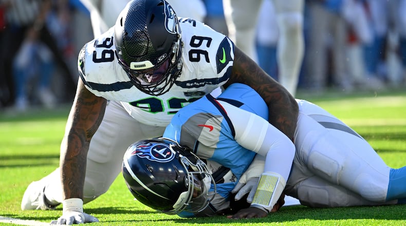 Seattle Seahawks defensive end Leonard Williams (99) sacks Tennessee Titans quarterback Cam Ward during the second half of an NFL football game Sunday, Nov. 23, 2025, in Nashville, Tenn. (John Amis/AP)