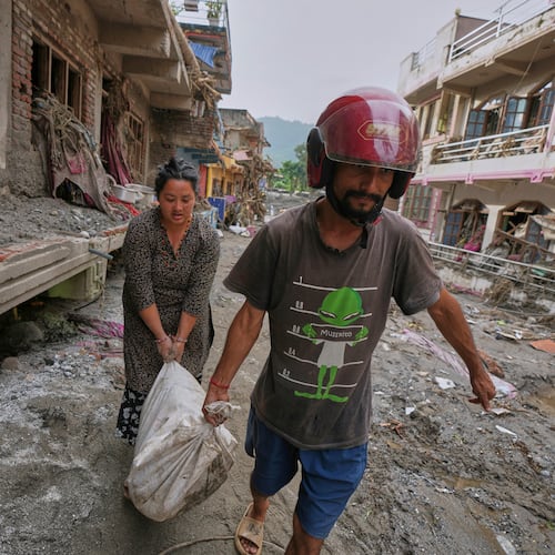 Residents salvage their belongings from damaged houses after flash flooding in the Devighat area of Nuwakot district in Nepal, Friday, Aug. 28, 2026. (AP Photo/Rajesh Kumar Singh)
