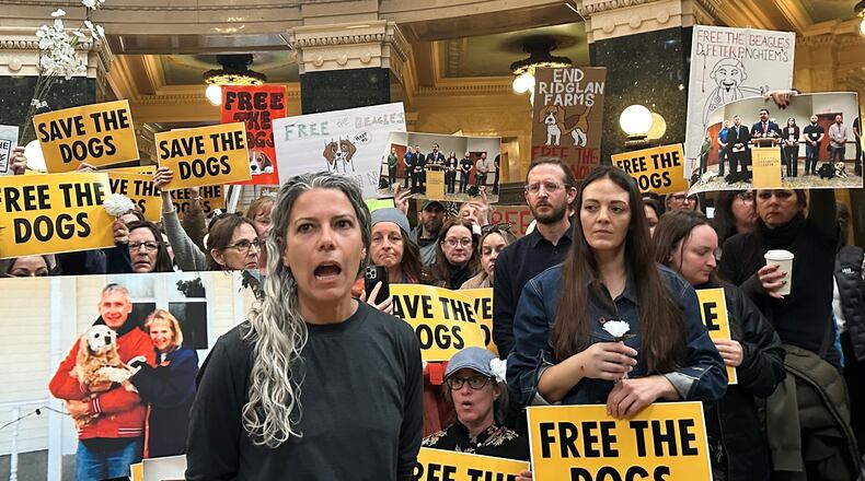 Rebekah Robinson, the president of Dane4Dogs, center left, speaks at a protest at the Wisconsin State Capitol demanding that the governor and attorney general do what they can to shut down a beagle breeding and research facility, Monday, April 20, 2026, in Madison, Wis. (AP Photo/Scott Bauer)