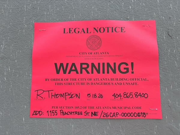 A legal notice from the city of Atlanta dated Monday, May 18, 2026, and posted on the work site of the Campanile building in Midtown Atlanta. (Zachary Hansen/AJC)