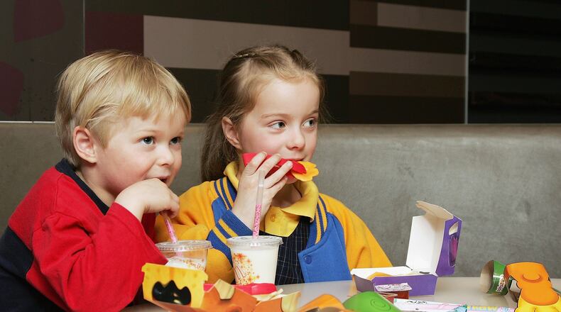 MELBOURNE, AUSTRALIA - AUGUST 29: Children eat a new Happy Meal at the McDonald's restaurant in Collingwood on August 29, 2006 in Melbourne, Australia. The new Happy Meal is a low fat alternative to the fast food chain's traditional Happy Meal. Childhood obesity is a major health issue in Australia and has tripled in the last 20 years with one in six Australian children classed as obese. (Photo by Kristian Dowling/Getty Images)