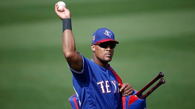 Texas Rangers third baseman Adrian Beltre tosses a baseball to a fan during the fifth inning of the team's spring training baseball game against the Chicago White Sox on Thursday, March 8, 2018, in Surprise, Ariz. Going into his 21st big-league season, Beltre is one of only two current players who have played at least 20 MLB seasons.(AP Photo/Ross D. Franklin)