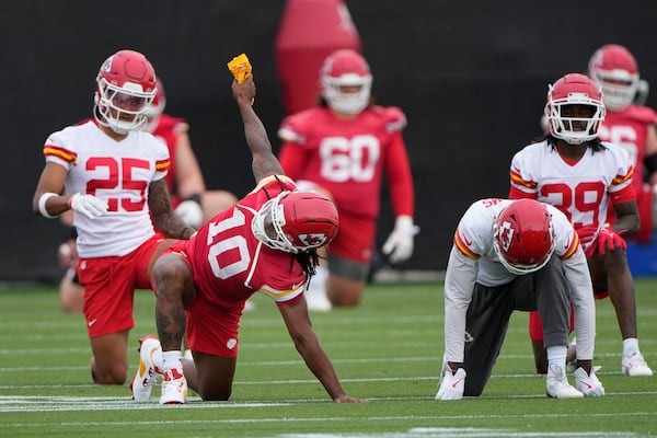 Kansas City Chiefs running back Isiah Pacheco (10) stretches with teammates during the NFL football team's practice Tuesday, June 17, 2025, in Kansas City, Mo. (AP Photo/Charlie Riedel)
