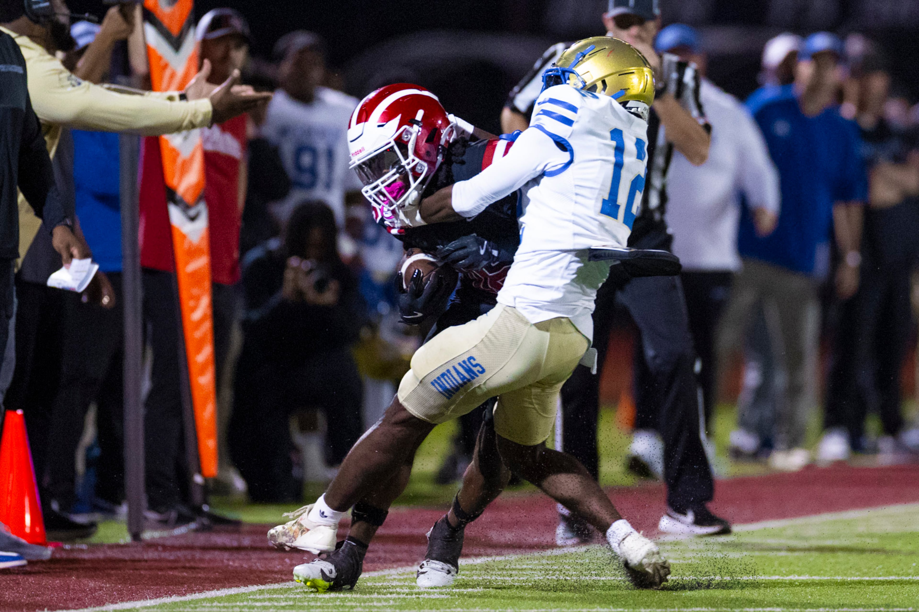 Hillgrove wide receiver Preston Wooten (16) gets tackled by McEachern quarterback Calvin Pittman Jr (12) at Cobb Energy Hillgrove Stadium in Powder Springs, GA on Friday, October 17th, 2025. (Oscar Guevara Saenz for the AJC)
