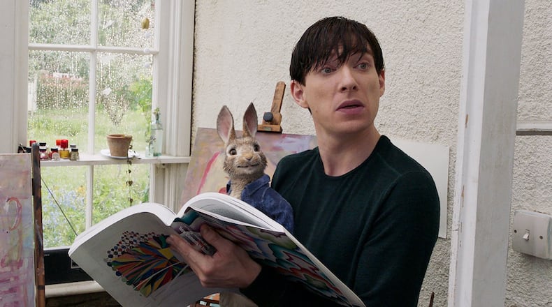 Peter Rabbit (James Corden) sits with Mr. McGregor (Domhnall Gleeson) in “Peter Rabbit.” Contributed by Sony Pictures