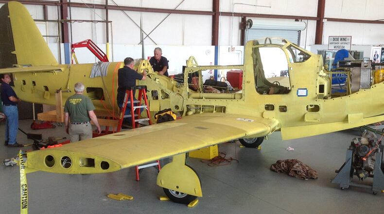 Members of the Commemorative Air Force's Dixie Wing work on restoring a P-63 Bell King Cobra at its hangar in Peachtree City. This weekend, the group hosts the 11th annual Peachtree City World War II Heritage Days. Contributed.
