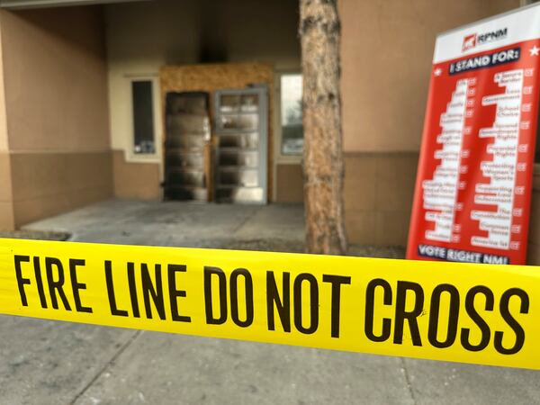 The charred entrance doors to the Republican Party of New Mexico headquarters sit propped up behind yellow tape in Albuquerque, New Mexico, on Monday, March 31, 2025. (AP Photo/Susan Montoya Bryan)