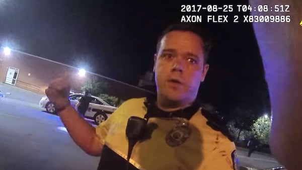 In a still image from body camera footage released Monday by Asheville, N.C., police officials, Officer Christopher Hickman talks to a supervisor, Sgt. Lisa Taube, the morning of Aug. 25, 2017, about a confrontation with Johnnie Rush. Rush, 33, was walking home from work that morning when Hickman and his partner accused the Cracker Barrel employee of jaywalking. The subsequent confrontation, caught on camera and shared by a local newspaper in February, led to community outrage and a felony charge of assault by strangulation against Hickman, who resigned in January.