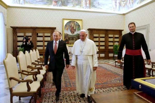 FILE - Pope Francis walks next to Russian President Vladimir Putin on the occasion of their private audience at the Vatican, Wednesday, June 10, 2015. (AP Photo/Gregorio Borgia, Pool, file)