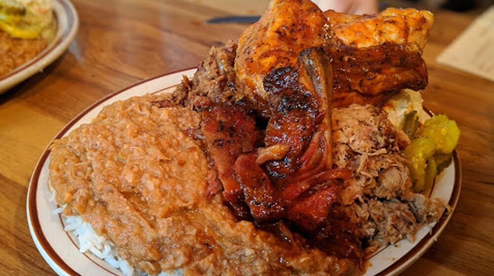 The Plantation Platter at Sconyers Bar-B-Que includes a choice of a quarter-chicken or sliced turkey along with two ribs, chopped beef and chipped pork as well as hash, pickles and a side of coleslaw or potato salad. CONTRIBUTED BY PAULA PONTES