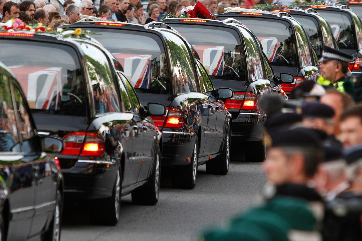 FILE - The coffins of seven British soldiers killed in Afghanistan, are driven through the town of Wootton Bassett, England, after repatriation to Britain, Tuesday, June 29, 2010. (AP Photo/Lefteris Pitarakis, file)