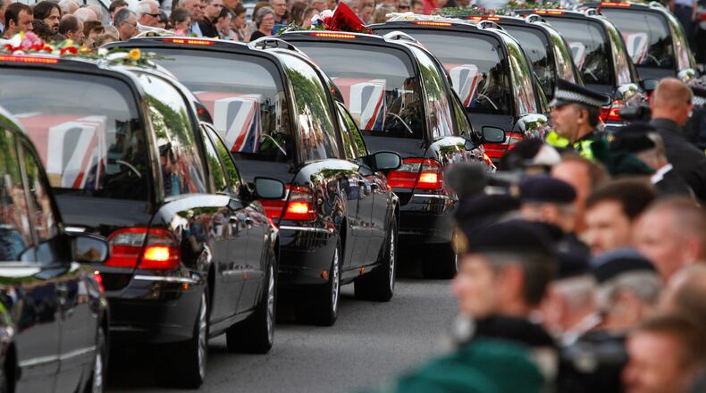 FILE - The coffins of seven British soldiers killed in Afghanistan, are driven through the town of Wootton Bassett, England, after repatriation to Britain, Tuesday, June 29, 2010. (AP Photo/Lefteris Pitarakis, file)