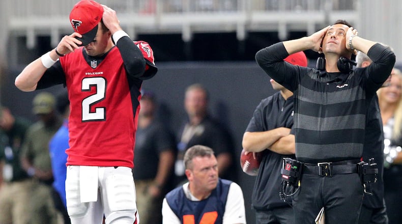 Atlanta Falcons quarterback Matt Ryan and offensive coordinator Steve Sarkisian react on the sidelines as the New Orleans Saints win  on a Drew Brees touchdown in overtime  on Sunday, Sept 23, 2018, in Atlanta.