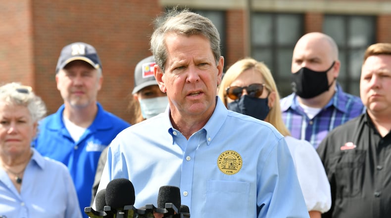 Georgia Gov. Brian Kemp speaks to the media outside Newnan High School in the aftermath of the tornado that tore through the Newnan on Saturday. Kemp’s office that the governor was exposed to a person with COVID-19 while touring the storm damage. He tested negative for the disease early Monday. (Hyosub Shin / Hyosub.Shin@ajc.com)