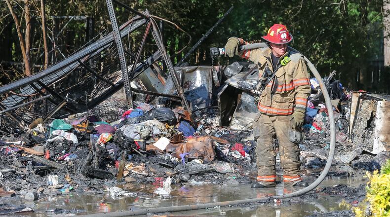 The amount of stuff in a house on Panhandle Road in Hampton made it difficult for firefighters “to put out all the hot spots,” officials said. JOHN SPINK / JSPINK@AJC.COM