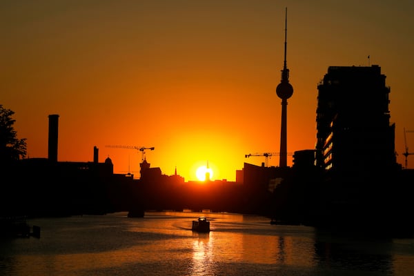 The Television Tower silhouettes in the sunset on a day with hot summer weather in Berlin, Germany, Tuesday, July 1, 2025. (AP Photo/Markus Schreiber)