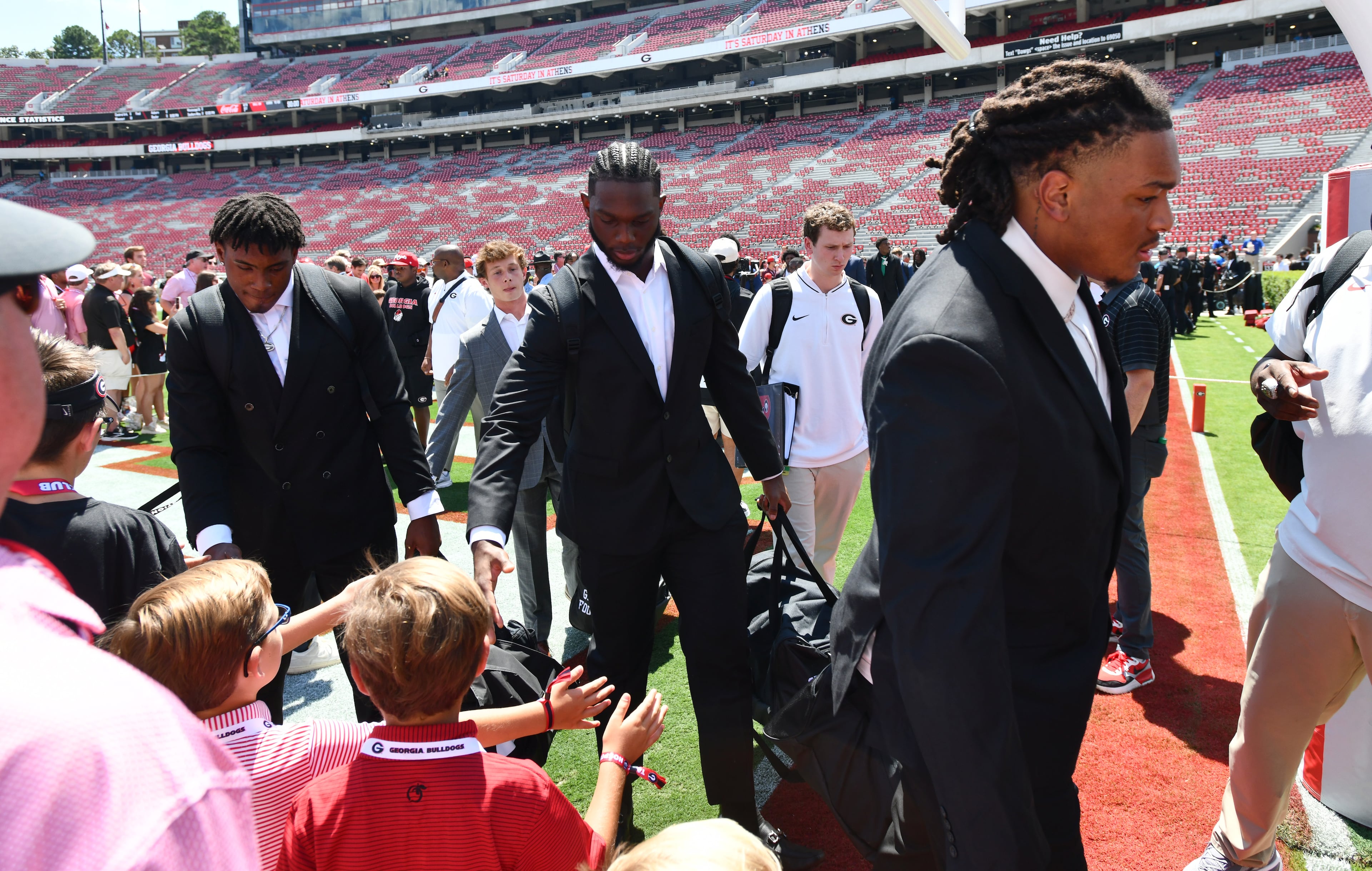 Georgia players are greeted by fans during Dawgs Walk before Georgia football's season opener and home opener against Marshall at Sanford Stadium, Saturday, August 30, 2025, in Athens. (Hyosub Shin / AJC)