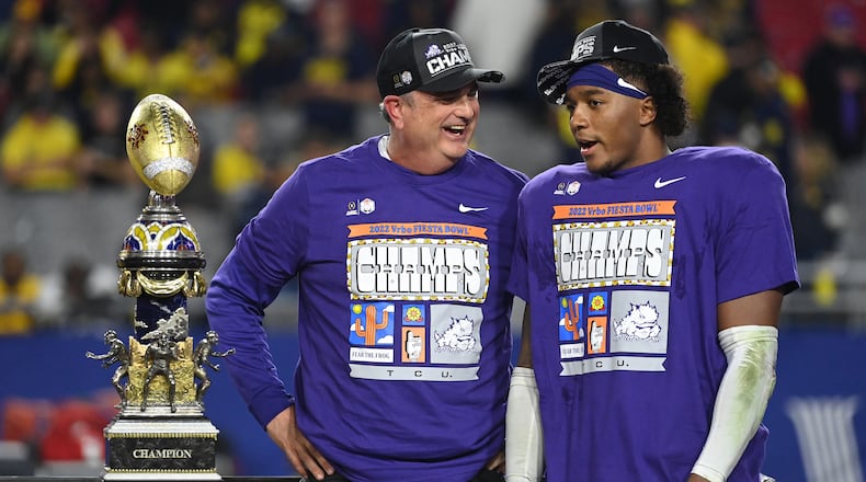 TCU coach Sonny Dykes celebrates with linebacker Dee Winters after the Horned Frogs defeated Michigan 51-45 in the Fiesta Bowl. (Norm Hall/TNS)