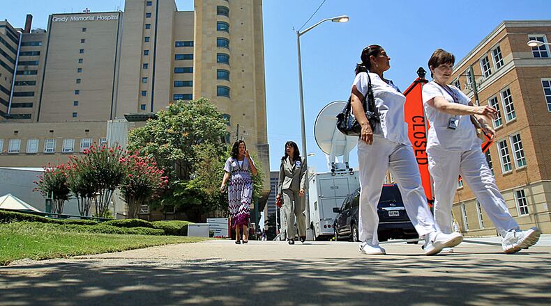 Medical personnel leave Grady Memorial Hospital for lunch. A proposed 2014 budget to be presented to the Fulton Board of Commissioners Wednesday would cut funding for Grady by $25 million.